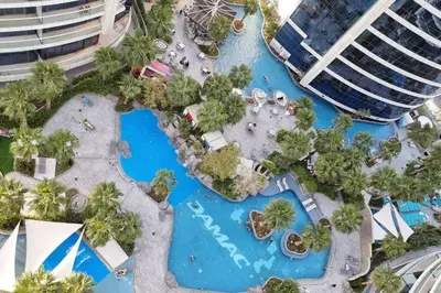 an aerial view of a pool at a resort at Luxury Paramount Hotel Apt A662 in Dubai