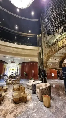 a lobby with couches and tables in a building at Luxury Paramount Hotel Apt A662 in Dubai
