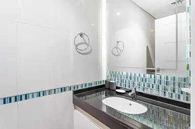 a bathroom with a sink and a mirror at StoneTree - Damac Heights 1BR apartment in Dubai