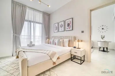 a white bedroom with a large bed and a window at Timeless 1BR at Binghatti Avenue Al Jaddaf by Deluxe Holiday Homes in Dubai