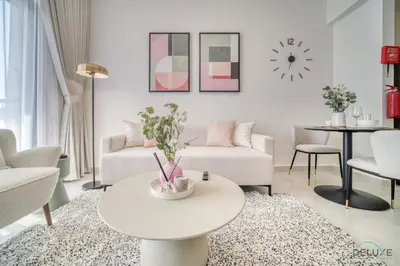a living room with a white couch and a table at Timeless 1BR at Binghatti Avenue Al Jaddaf by Deluxe Holiday Homes in Dubai