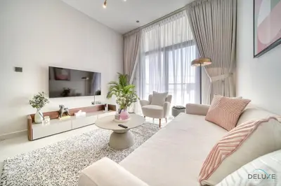 a living room with a couch and a tv at Timeless 1BR at Binghatti Avenue Al Jaddaf by Deluxe Holiday Homes in Dubai