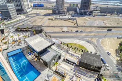 an aerial view of a city with a swimming pool at Soothing 1BR at Binghatti Avenue Al Jaddaf by Deluxe Holiday Homes in Dubai