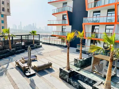 a building with benches and palm trees in front of it at Soothing 1BR at Binghatti Avenue Al Jaddaf by Deluxe Holiday Homes in Dubai