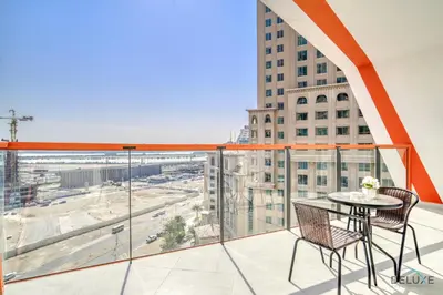 a balcony with a table and chairs and a view of a city at Soothing 1BR at Binghatti Avenue Al Jaddaf by Deluxe Holiday Homes in Dubai