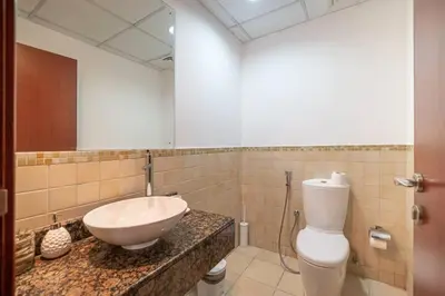 a bathroom with a sink and a toilet at StoneTree - Spacious 2 BR near JBR beach in Dubai