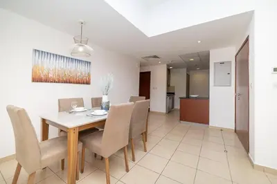 a dining room with a table and chairs at StoneTree - Spacious 2 BR near JBR beach in Dubai