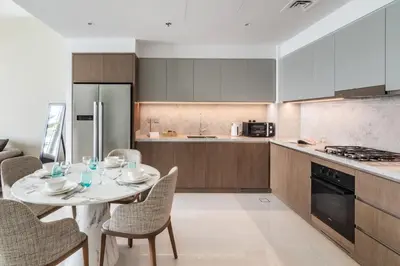 a kitchen with a table and chairs in a kitchen at Sea view 2-Bedroom - Beach Isle in Dubai