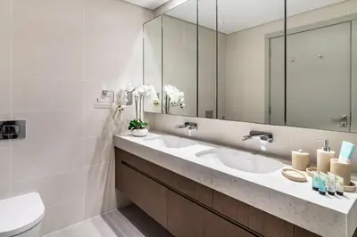 a bathroom with two sinks and a mirror at Sea view 2-Bedroom - Beach Isle in Dubai