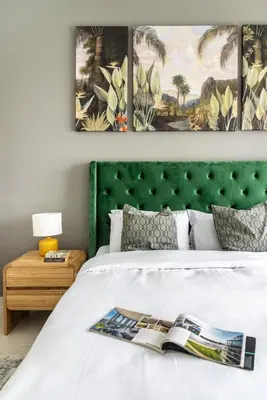 a bedroom with a bed with a green headboard at Sea view 2-Bedroom - Beach Isle in Dubai
