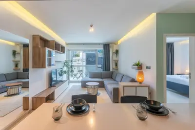 a living room with a couch and a table at West Avenue - Chic One Bedroom in Dubai