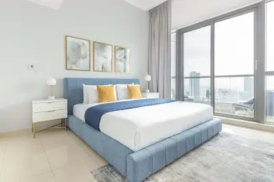 a bedroom with a large bed and a large window at Frank Porter - Bay Central 1 in Dubai