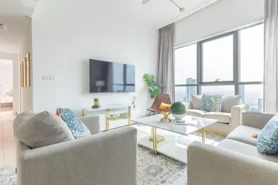 a living room with two couches and a tv at Frank Porter - Bay Central 1 in Dubai