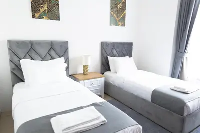 a bedroom with two beds and a table at SHAMS 2 bedrooms apartment on JBR by HAPPY SEASON in Dubai