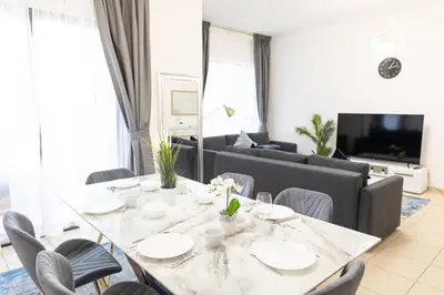 a dining room with a table and a couch at SHAMS 2 bedrooms apartment on JBR by HAPPY SEASON in Dubai