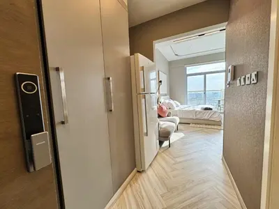 a room with a door to a room with a bed at Warm and Elegant Studio in Dubai in Dubai