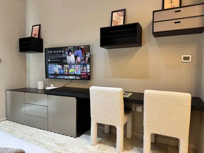 a home office with a desk and two chairs at Warm and Elegant Studio in Dubai in Dubai