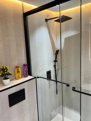 a shower with a glass door in a bathroom at Warm and Elegant Studio in Dubai in Dubai