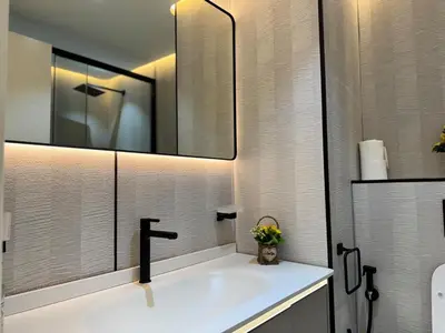 a bathroom with a sink and a mirror at Warm and Elegant Studio in Dubai in Dubai