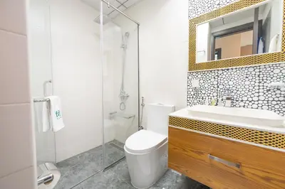 a bathroom with a toilet and a sink and a mirror at FAM Living - Bayz Tower by Danube - Business Bay in Dubai