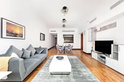 a living room with a couch and a table at StoneTree - 1BR apartment with Beach Access Fairmont in Palm Jumeirah in Dubai