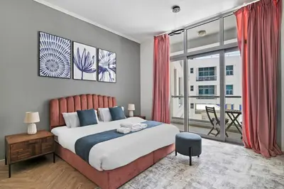a bedroom with a large bed and a large window at StoneTree - New Cozy Studio in Dubai Marina in Dubai