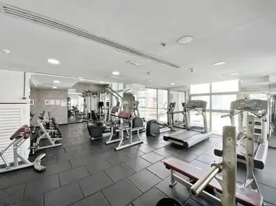 a gym with several treadms and machines in a room at StoneTree - New Cozy Studio in Dubai Marina in Dubai