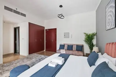 a large bedroom with a large bed and a couch at StoneTree - New Cozy Studio in Dubai Marina in Dubai