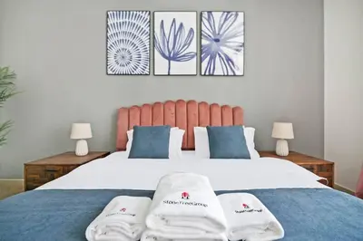 a bedroom with a bed with two towels on it at StoneTree - New Cozy Studio in Dubai Marina in Dubai