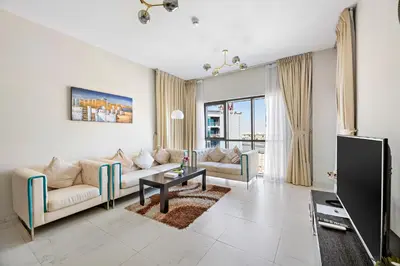 a living room with a couch and a table at StoneTree - Spacious 2BR in Peaceful Community in Dubai