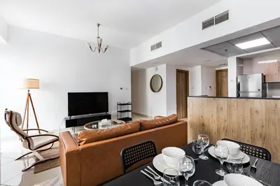 a living room with a couch and a table at Tranquil Retreat With Epic Marina View in Dubai