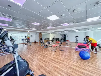 a gym with a man working out in a gym at Tranquil Retreat With Epic Marina View in Dubai