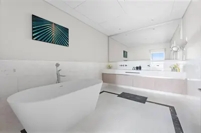 a white bathroom with a tub and a sink at StoneTree - Luxurious 1BR with Amazing Sea View in Dubai