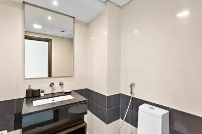 a bathroom with a sink and a mirror at StoneTree - Stylish 1BR & Pool with Burj Khalifa Views in Dubai