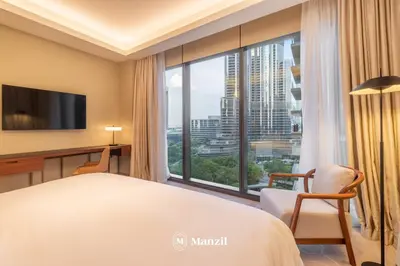a hotel room with a bed and a large window at Address Opera - Lux 3 BR with Full Burj Khalifa View near Dubai Mall in Dubai