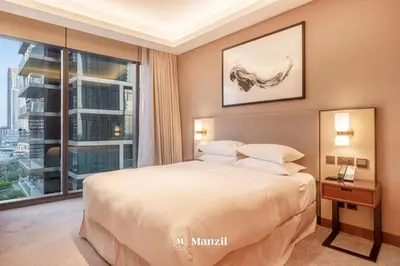 a bedroom with a large bed and a large window at Address Opera - Lux 3 BR with Full Burj Khalifa View near Dubai Mall in Dubai