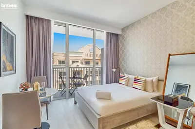 a hotel room with a bed and a balcony at bnbmehomes - Luma21 in Dubai