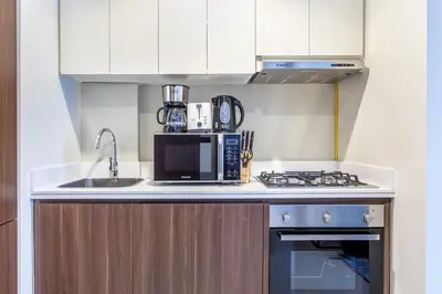 a kitchen with a sink and a microwave at New 1 bedroom with Canal View - Close to Downtown in Dubai