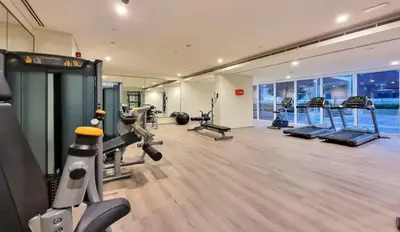 a gym with treadmills and cardio equipment in a building at New 1 bedroom with Canal View - Close to Downtown in Dubai