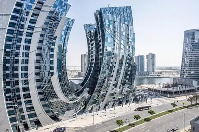 a view of two tall glass buildings in a city at New 1 bedroom with Canal View - Close to Downtown in Dubai