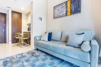 a blue couch in a living room with a table at New 1 bedroom with Canal View - Close to Downtown in Dubai