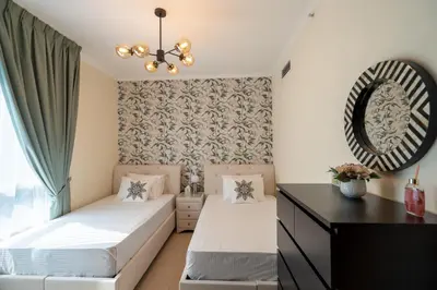 a bedroom with two beds and a mirror at INA HOMES - 2BHK Residences Tower 1 in Dubai