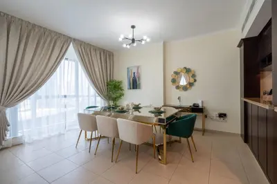 a dining room with a table and chairs at INA HOMES - 2BHK Residences Tower 1 in Dubai