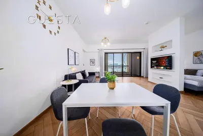 a living room with a white table and chairs at Jumeirah Beach Residence - Rimal 4, Dubai Marina in Dubai