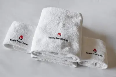 three towels with the words smart towel group on them at StoneTree - Modern Style of Studio in Resortz by Danube in Dubai