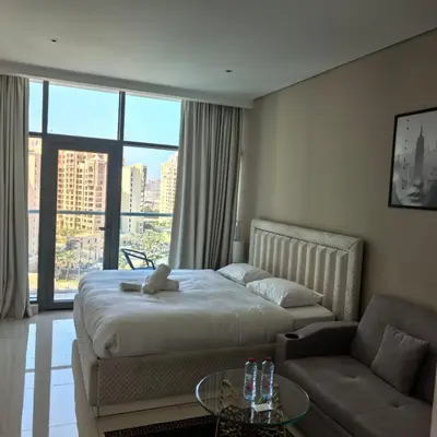 a hotel room with a bed and a couch at 7 Palm Jumeirah in Dubai