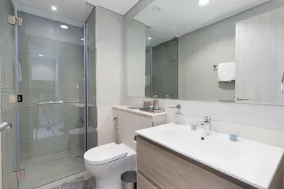 a bathroom with a toilet and a sink and a shower at Coastal Bay 1 Bedroom in Dubai