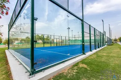 a tennis court with a net on a tennis court at Studio in Loreto 1A, DAMAC Hills - Host & Stay in Dubai