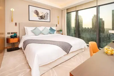 a bedroom with a large bed and a large window at Prime Retreats @ Address Residence Opera By Emaar in Dubai