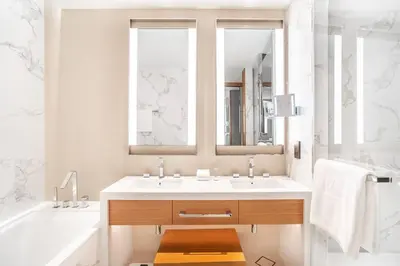 a bathroom with a sink and a tub and a mirror at Prime Retreats @ Address Residence Opera By Emaar in Dubai